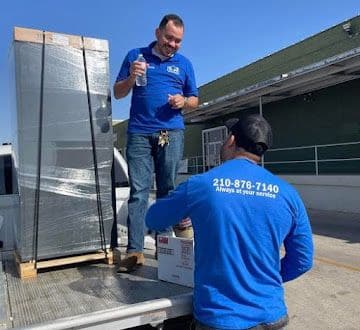 BB&M AC and Heating crew loading a new HVAC system for delivery